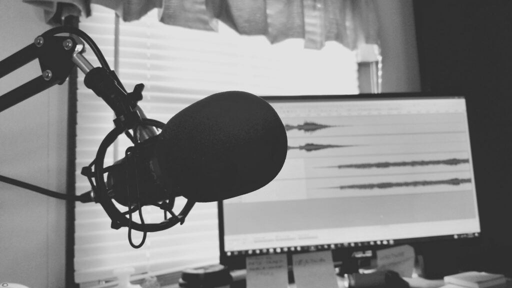 greyscale photography of podcast microphone