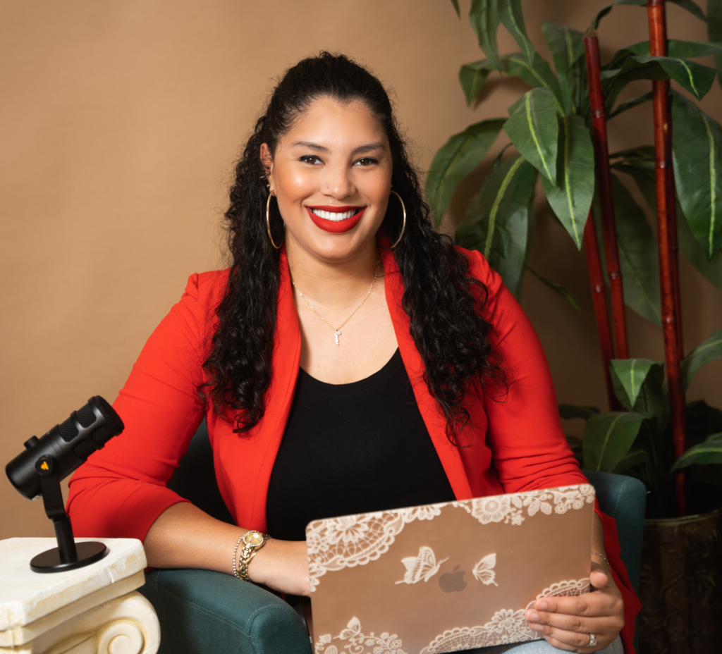 Heidy de la cruz, podcast coach posing with a red blazer and with her podcast set up