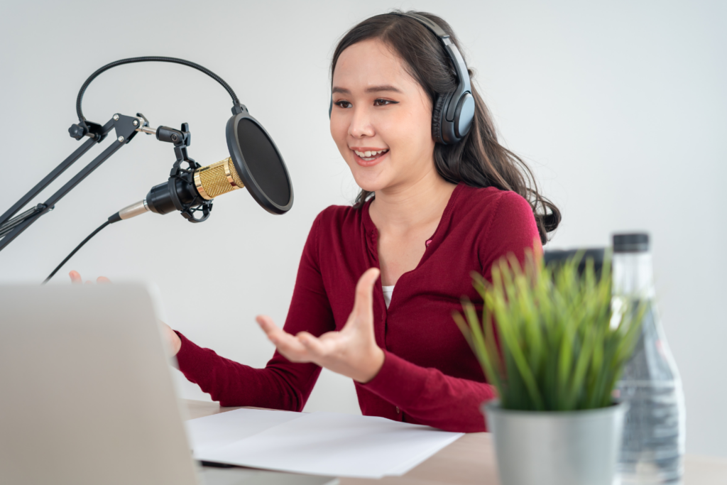 latina podcasters recording a new podcast episode smiling and embodying feeling confident that her email marketing for her podcast is also working